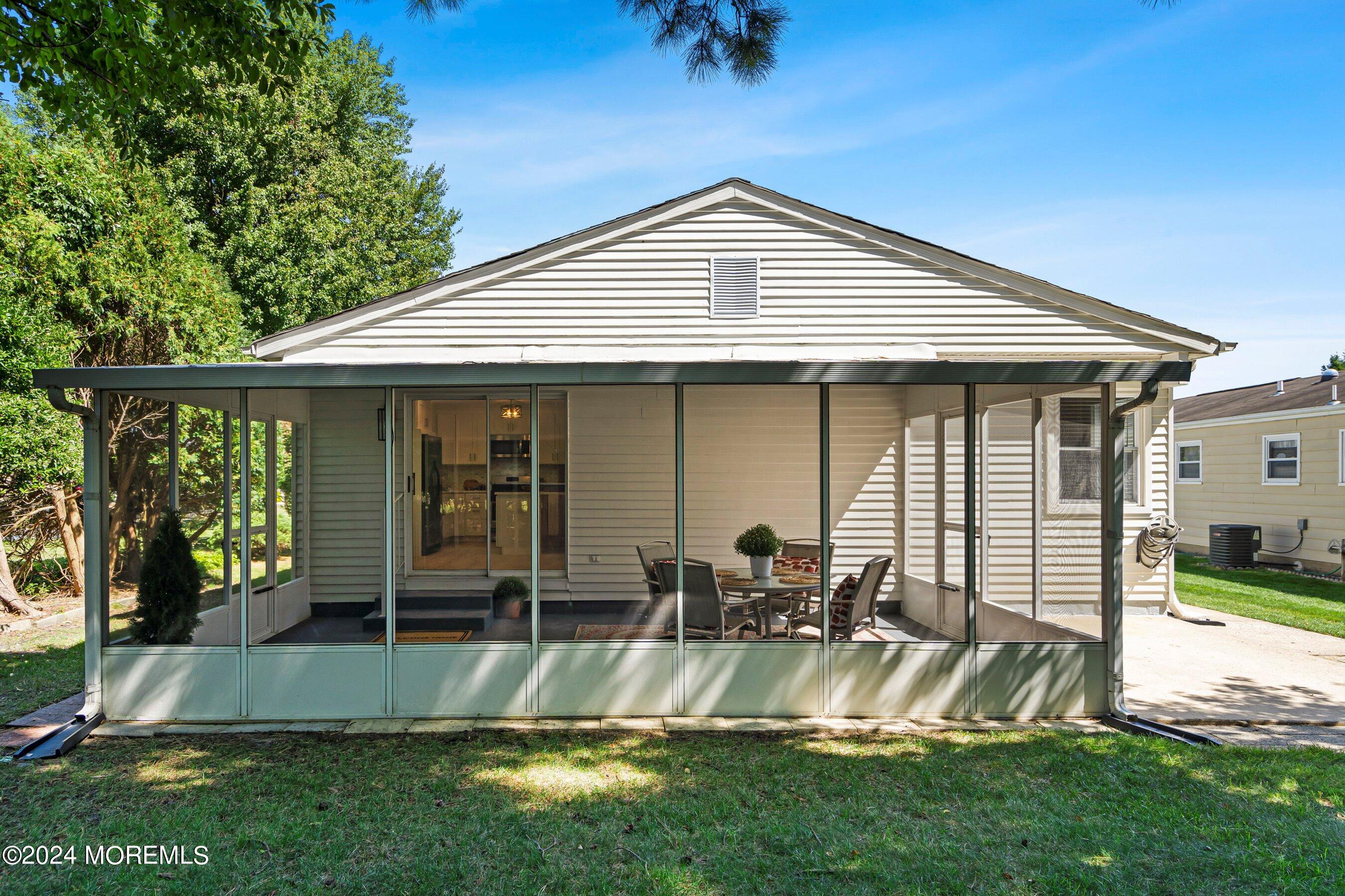21 Tapola Road Toms River, NJ 08757 - Photo 20 of 22 a view of a house with a yard potted plants and a table