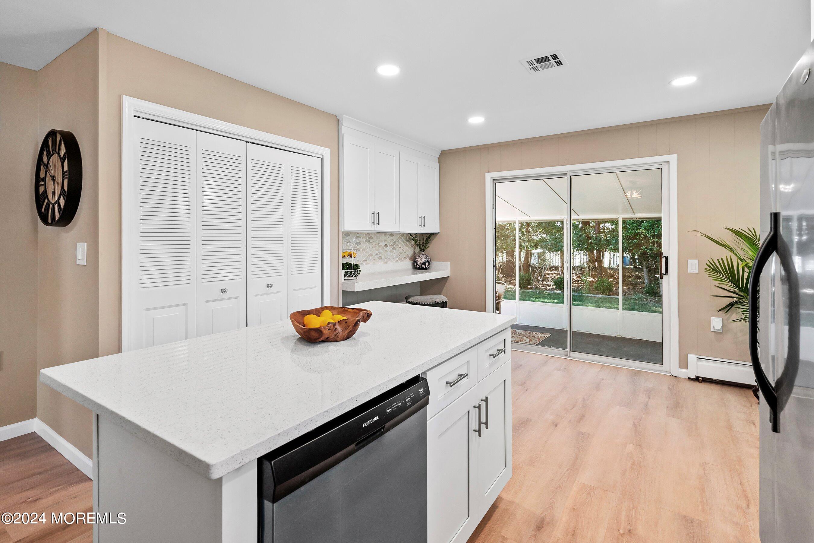 21 Tapola Road Toms River, NJ 08757 - Photo 9 of 22 a kitchen with a refrigerator a stove a sink and a cabinets