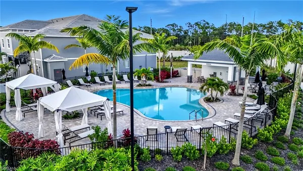 an aerial view of a house with garden space and swimming pool