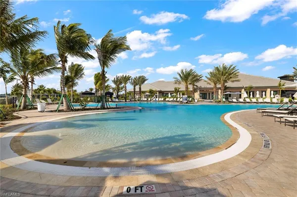 a view of a swimming pool with outdoor seating