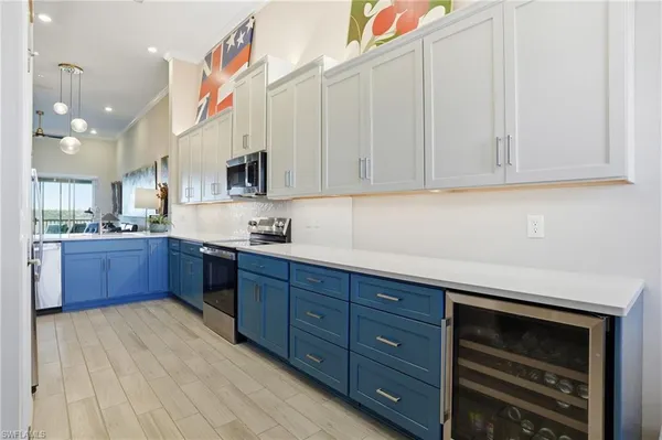 a kitchen with stainless steel appliances granite countertop a stove a sink and a microwave