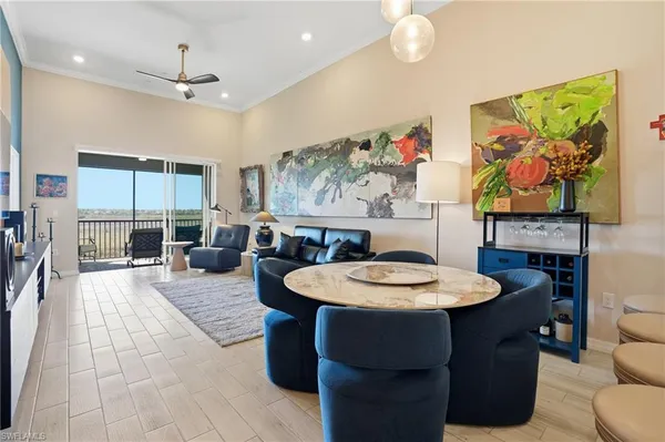 a living room with furniture a flat screen tv and kitchen view