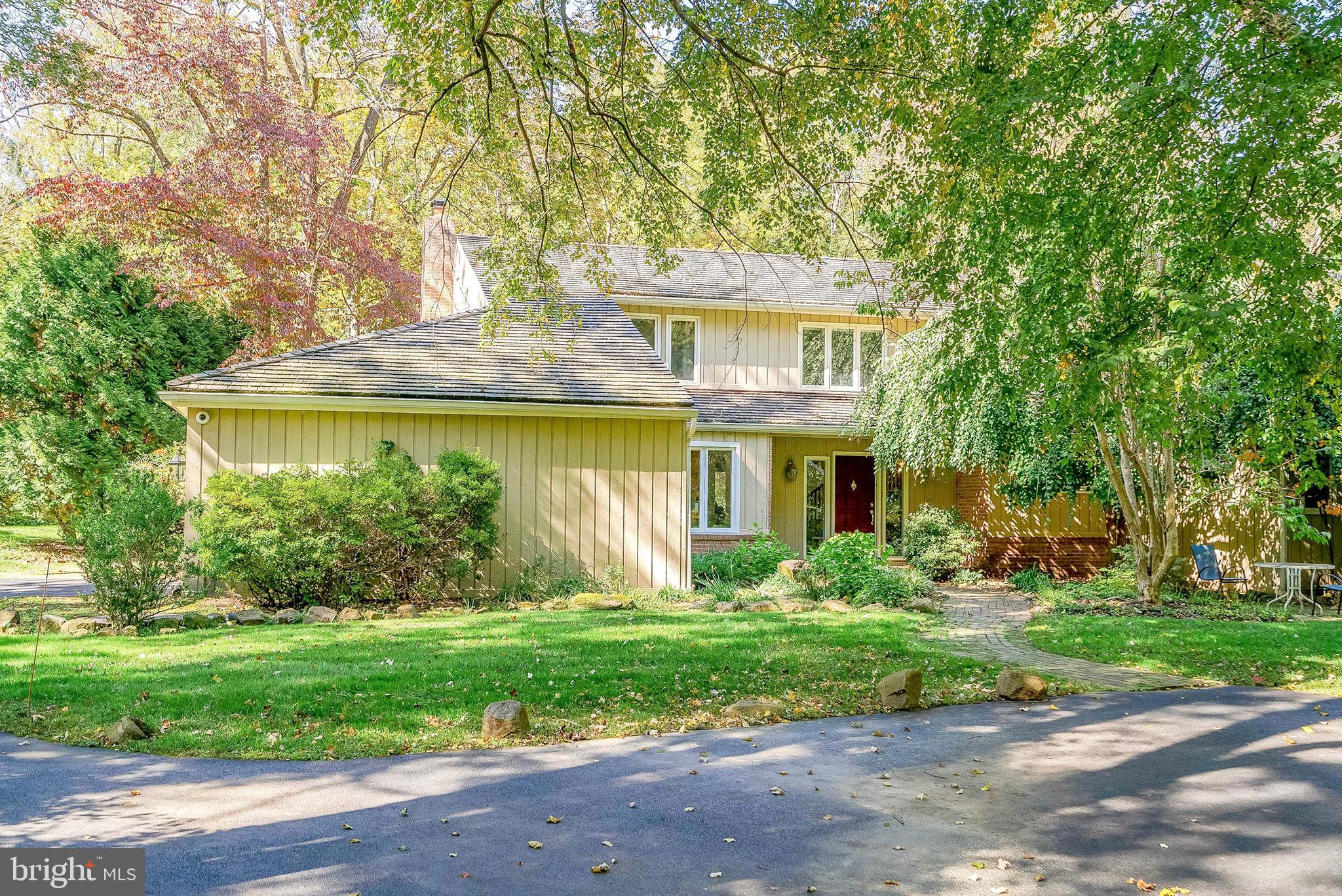 a front view of house with yard and green space
