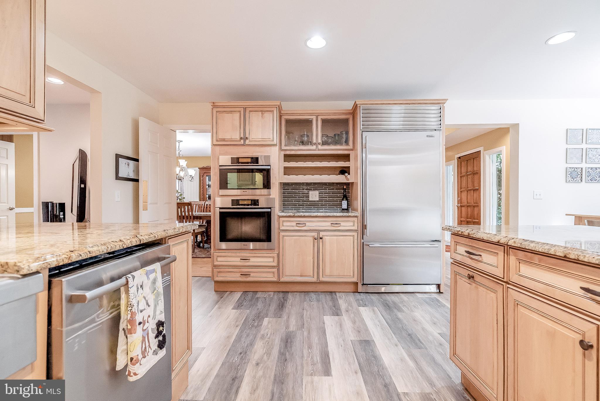 1361 South Leopard Road Berwyn, PA 19312 - Photo 6 of 33 a kitchen with stainless steel appliances kitchen island granite countertop a stove and a sink