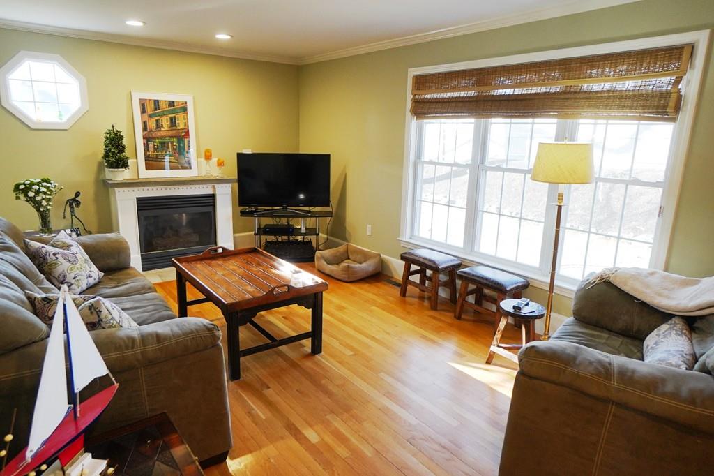 2 Dodge Road Marblehead, MA 01945 - Photo 4 of 16 a living room with furniture a fireplace and a flat screen tv