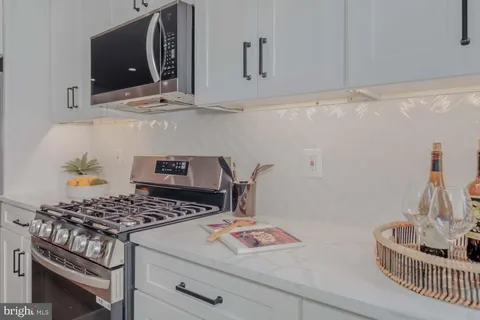 a kitchen with stove and cabinets