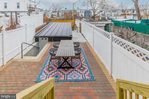 a view of a balcony with wooden floor and fence