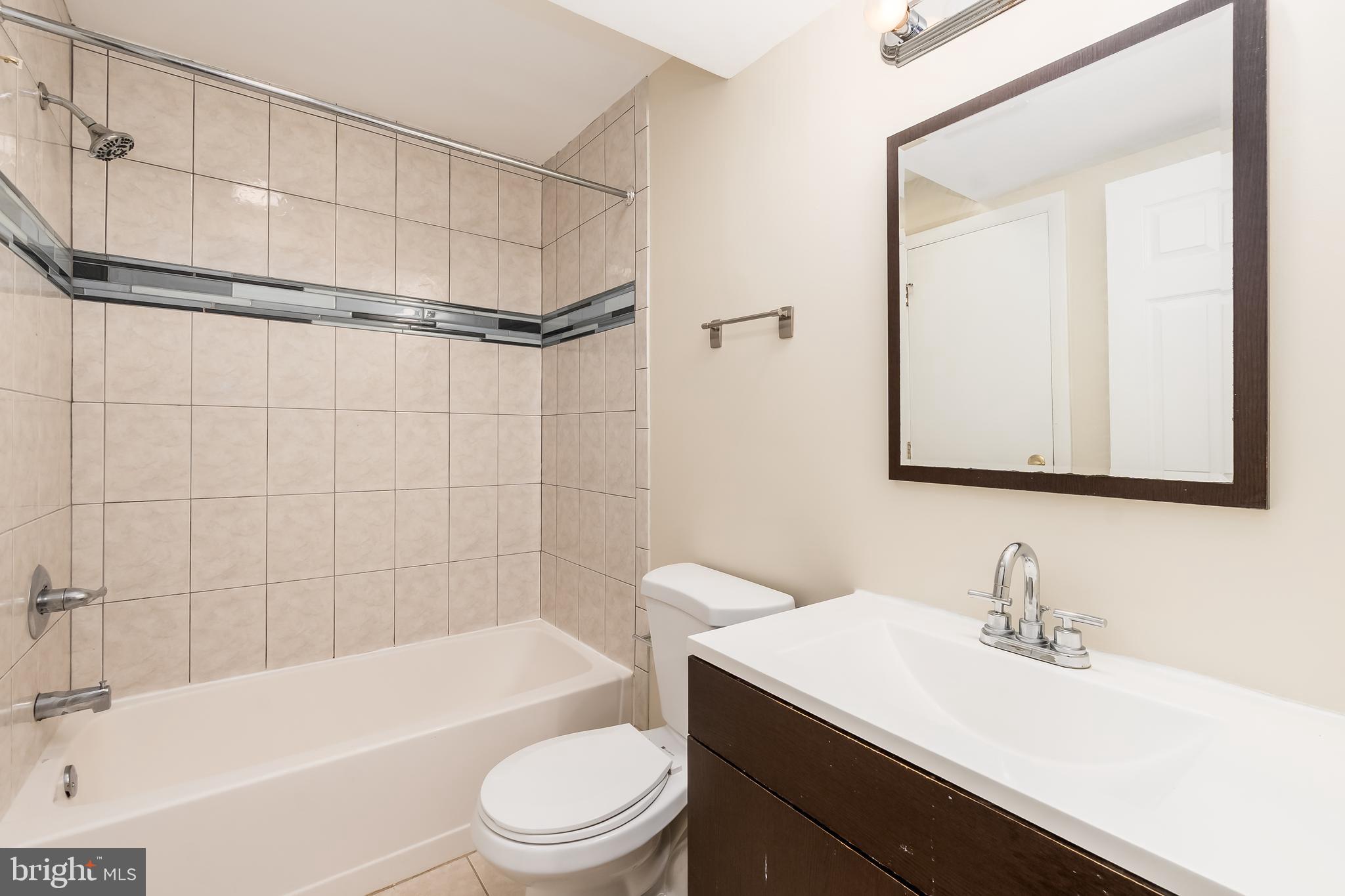 1713 Euclid Street Northwest, Unit 1 Washington, DC 20009 - Photo 12 of 27 a bathroom with a sink a toilet and shower