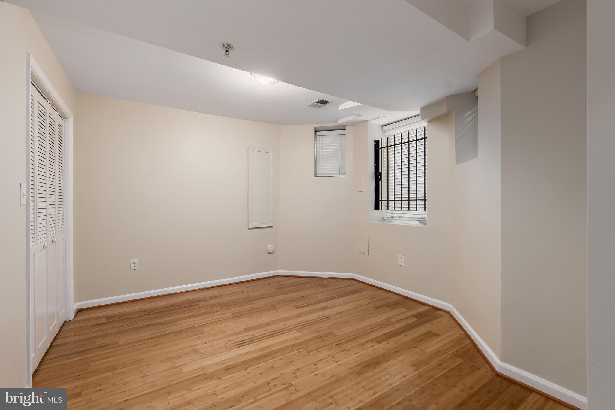 1713 Euclid Street Northwest, Unit 1 Washington, DC 20009 - Photo 14 of 27 a view of empty room with wooden floor