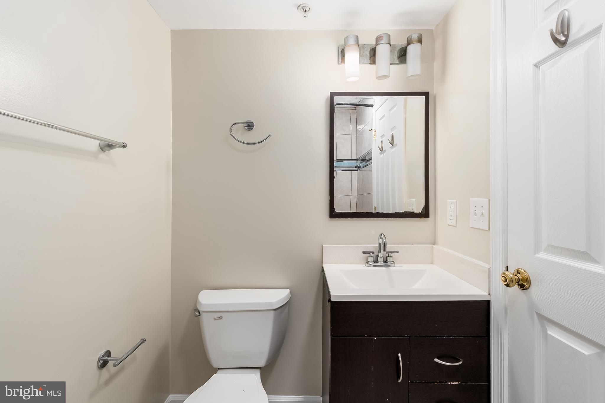 1713 Euclid Street Northwest, Unit 1 Washington, DC 20009 - Photo 18 of 27 a bathroom with a toilet sink and mirror
