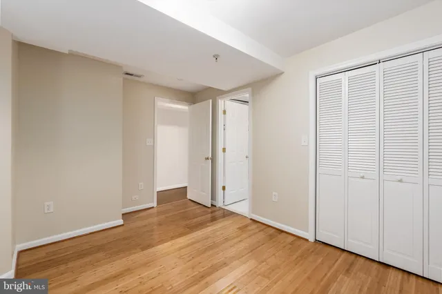 a view of an empty room with wooden floor