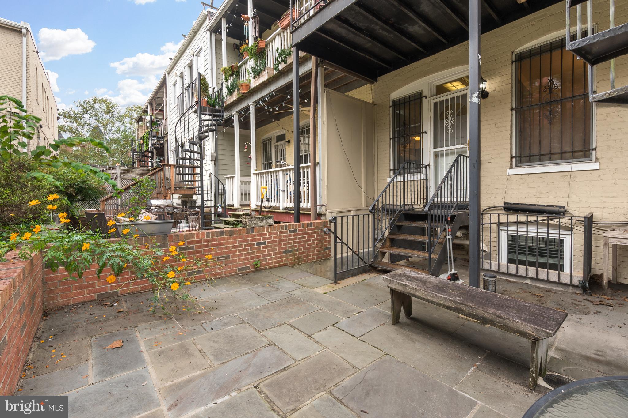 1713 Euclid Street Northwest, Unit 1 Washington, DC 20009 - Photo 24 of 27 a backyard of a house with barbeque oven table and chairs