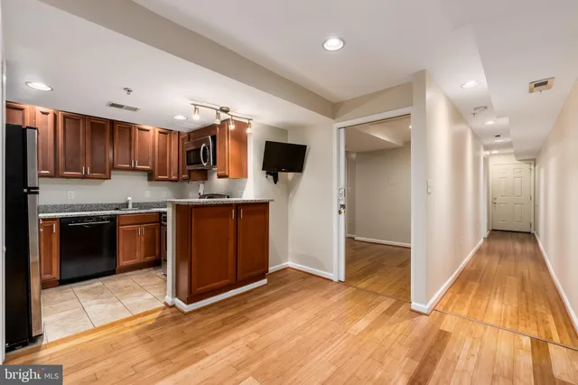a kitchen with stainless steel appliances granite countertop a stove and a microwave
