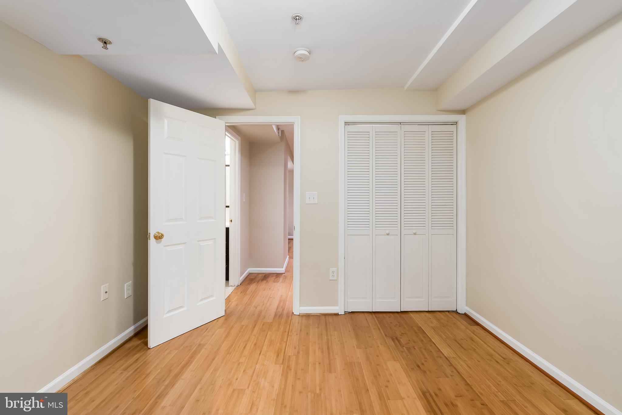 1713 Euclid Street Northwest, Unit 1 Washington, DC 20009 - Photo 8 of 27 an empty room with wooden floor