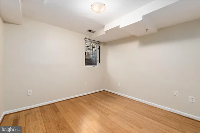 an empty room with wooden floor