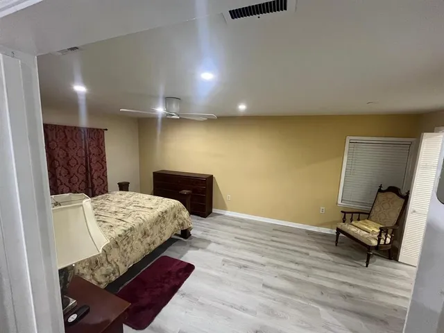 a bedroom with a bed and a chair