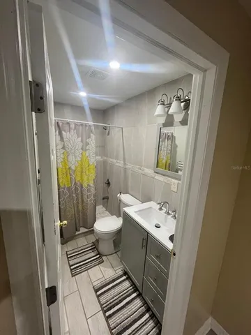 a bathroom with a toilet sink and shower