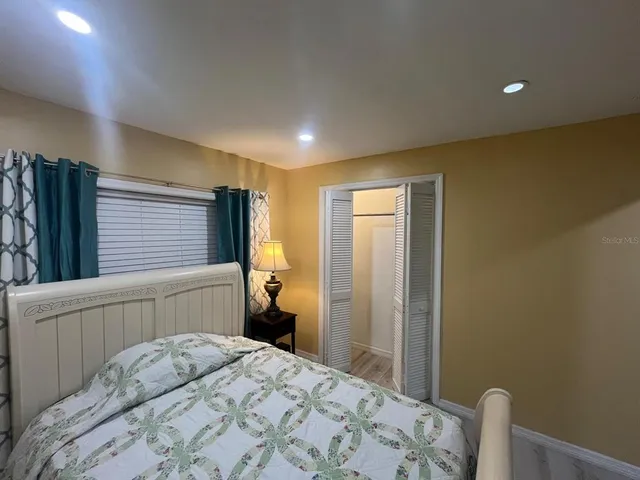 a bedroom with a bed and a dresser