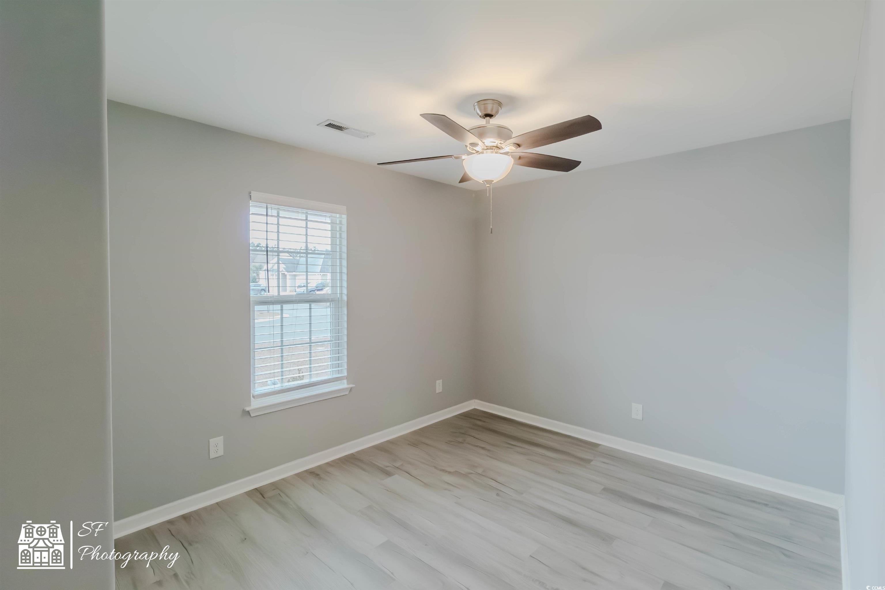290 Blue Rock Drive Longs, SC 29568 - Photo 5 of 21 Empty room featuring ceiling fan and light hardwoo