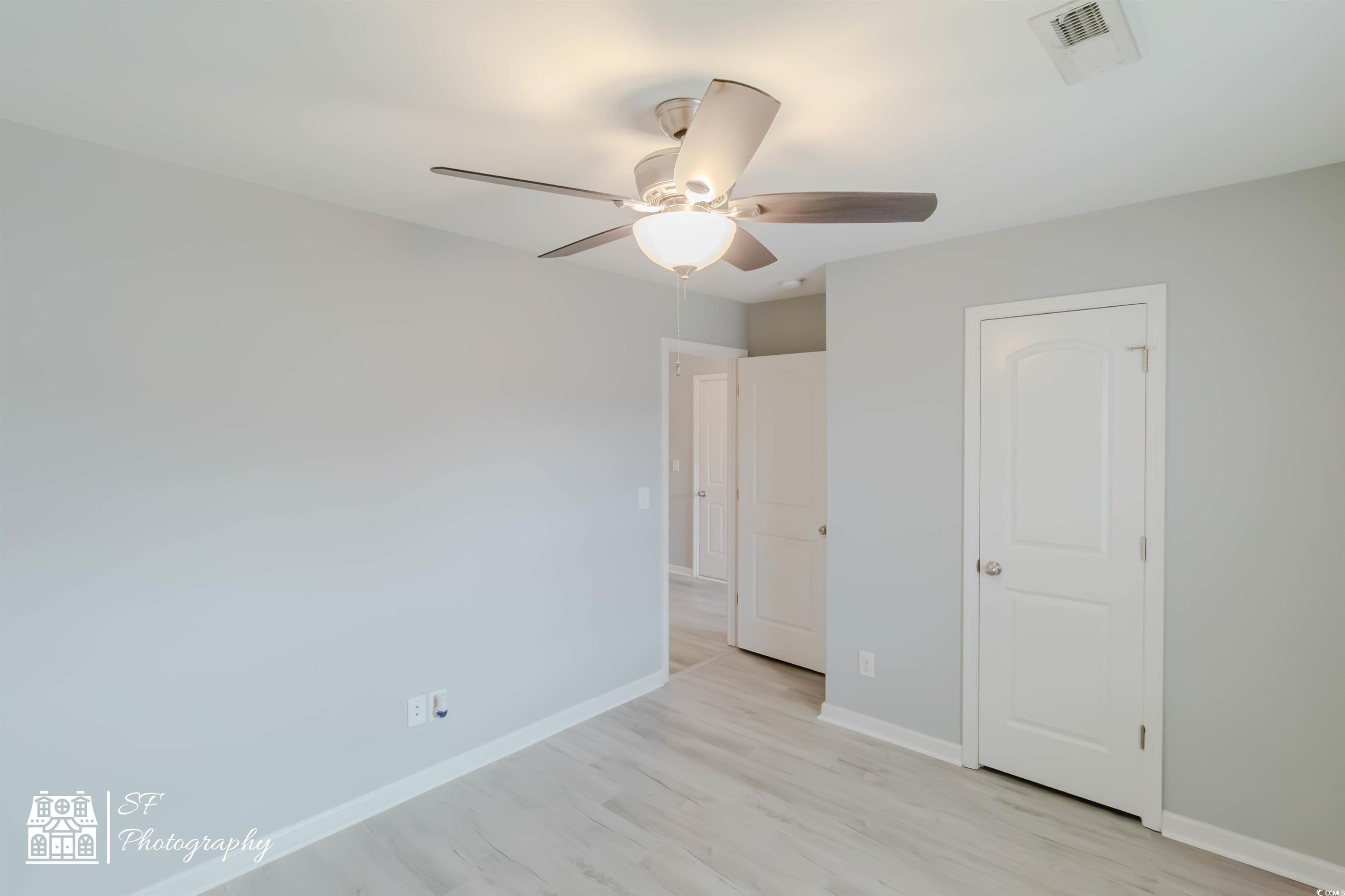 290 Blue Rock Drive Longs, SC 29568 - Photo 6 of 21 Unfurnished bedroom with ceiling fan and light woo