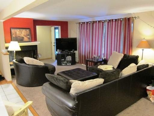 976 Ruth Drive Elgin, IL 60123 - Photo 2 of 15 a living room with furniture a fireplace and a flat screen tv