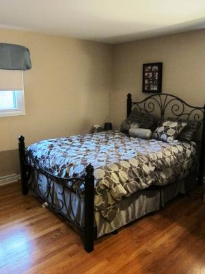 976 Ruth Drive Elgin, IL 60123 - Photo 9 of 15 a bed sitting in a bedroom next to a window