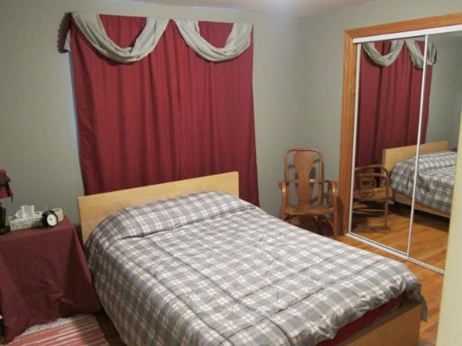 976 Ruth Drive Elgin, IL 60123 - Photo 10 of 15 a bedroom with a bed and dresser with wooden floor