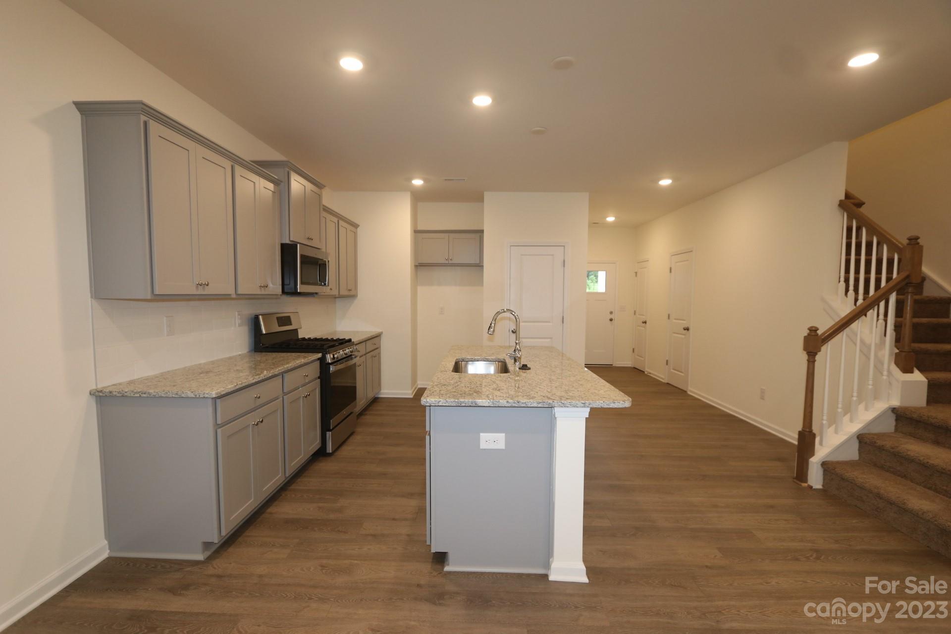 2825 Trinity Street Monroe, NC 28110 - Photo 2 of 6 a large kitchen with stainless steel appliances granite countertop a lot of counter space and wooden floor