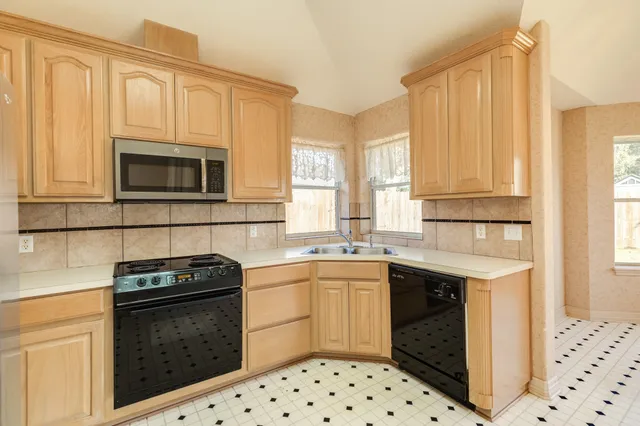 a kitchen with a sink stove and microwave