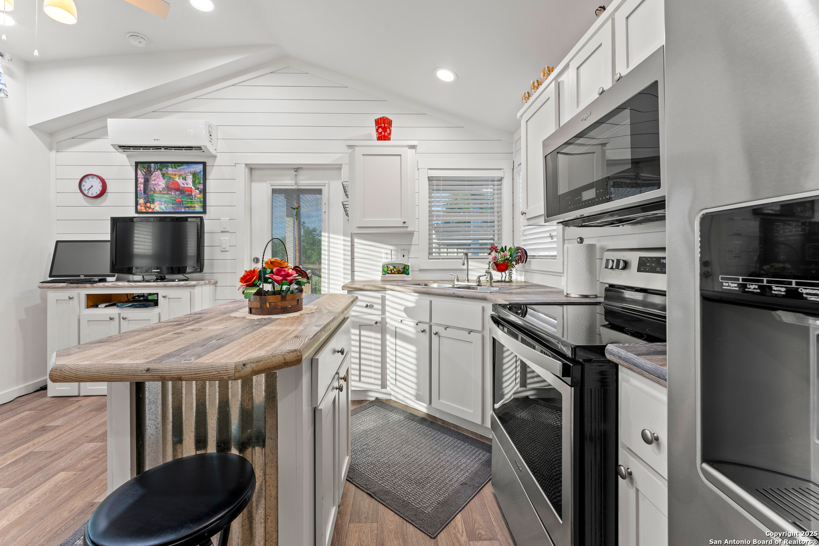 286 Highway 173 Bandera, TX 78003 - Photo 11 of 38 a kitchen that has a microwave a stove a sink and a refrigerator