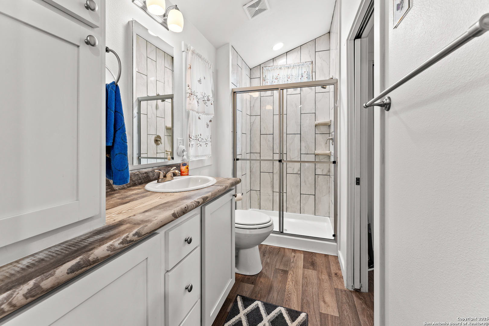 286 Highway 173 Bandera, TX 78003 - Photo 13 of 38 a bathroom with a granite countertop sink toilet and shower