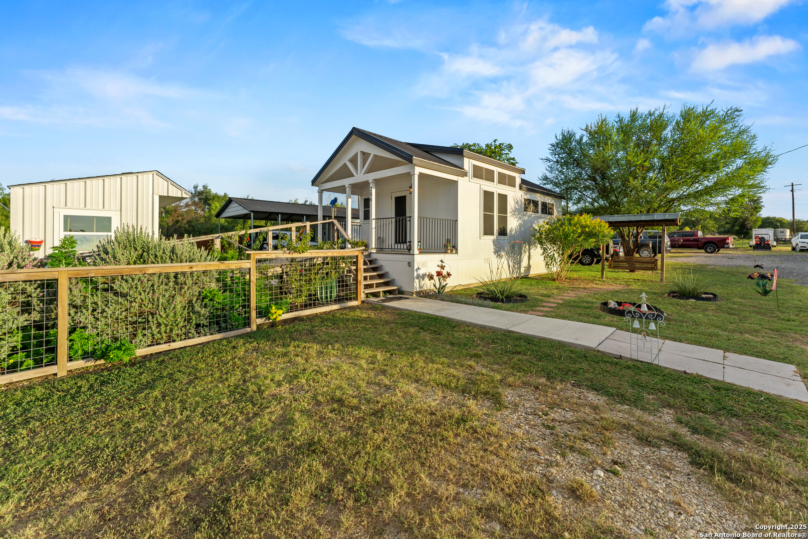 286 Highway 173 Bandera, TX 78003 - Photo 3 of 38 a front view of a house with a yard
