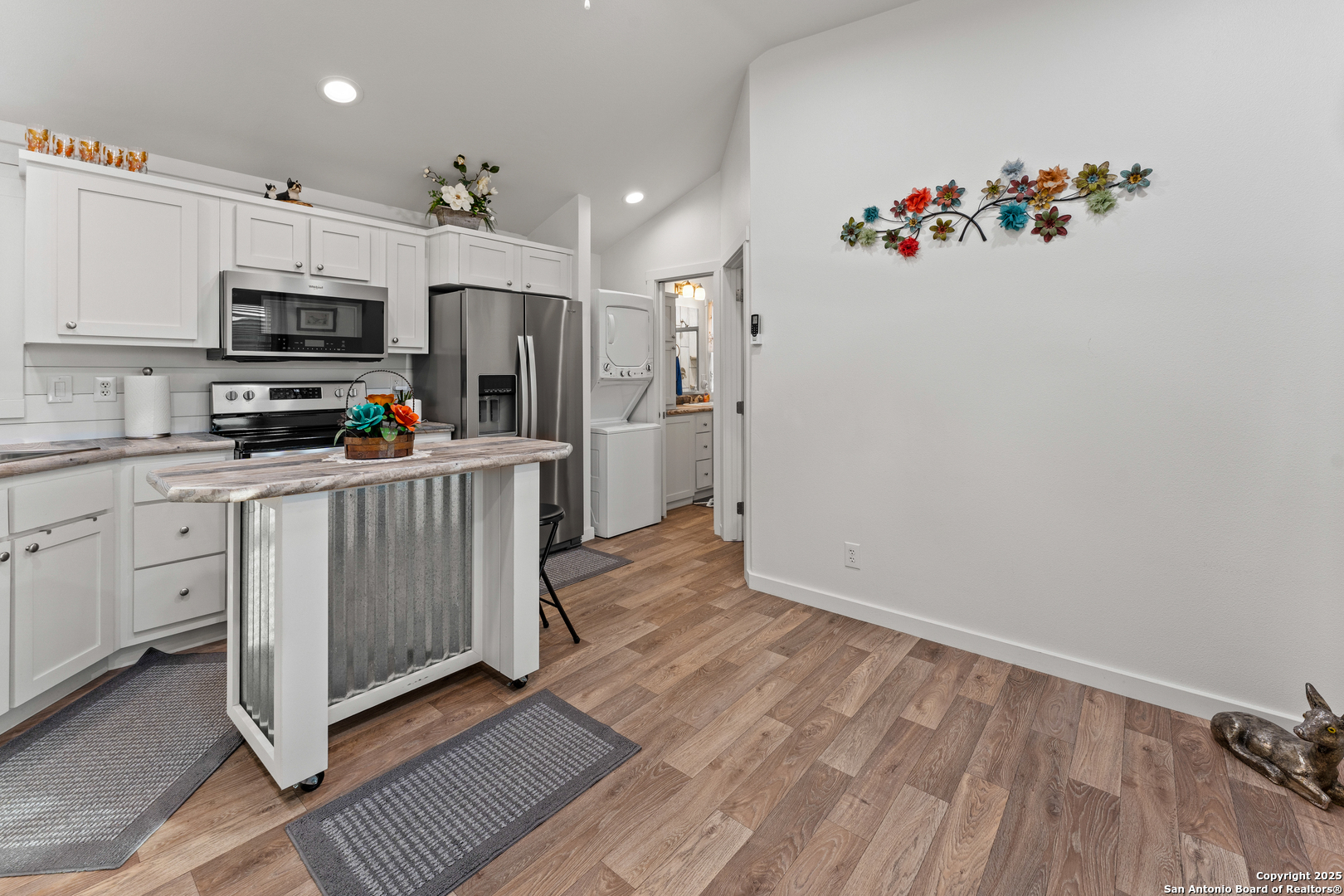 286 Highway 173 Bandera, TX 78003 - Photo 7 of 38 a kitchen that has a lot of white cabinets and stainless steel appliances