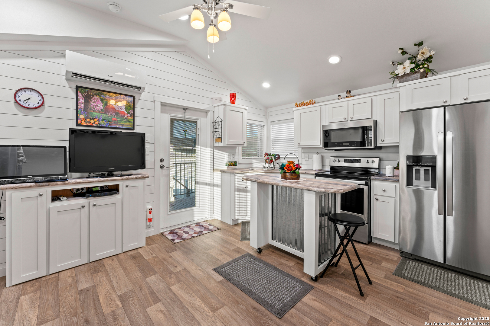 286 Highway 173 Bandera, TX 78003 - Photo 9 of 38 a kitchen with white cabinets and stainless steel appliances