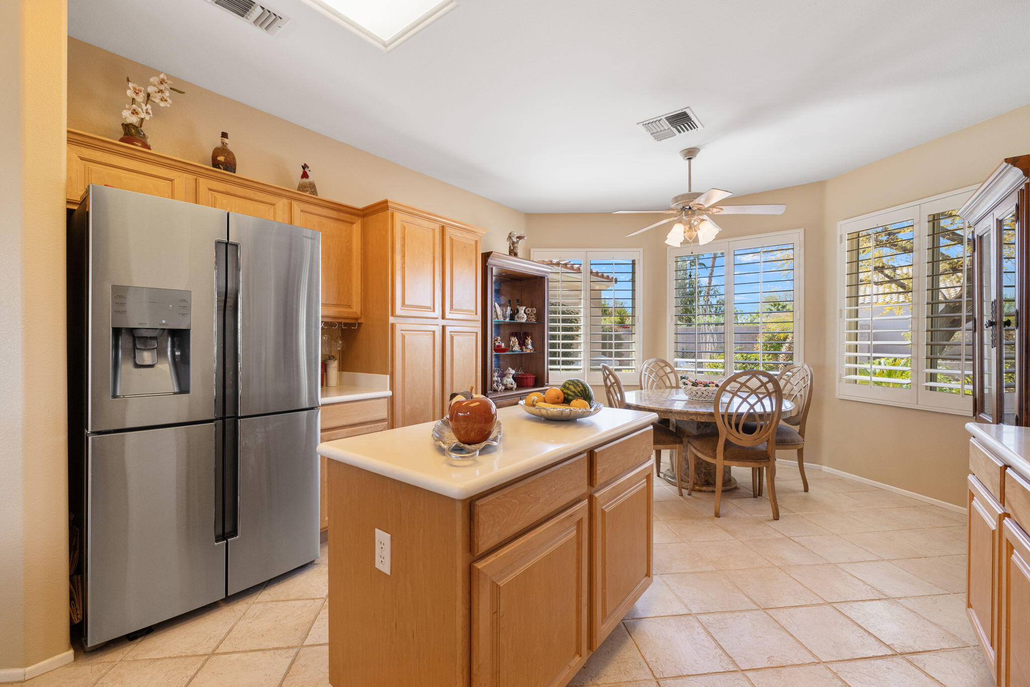 39611 Manorgate Road Palm Desert, CA 92211 - Photo 16 of 45 a kitchen with refrigerator a table and chairs