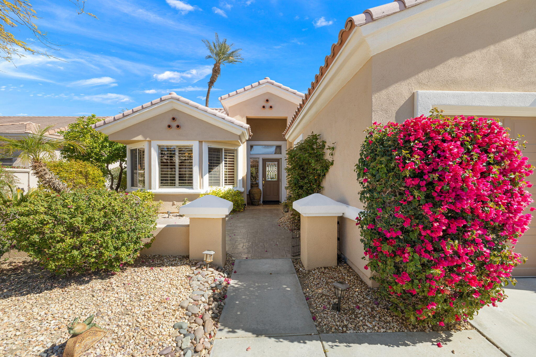 39611 Manorgate Road Palm Desert, CA 92211 - Photo 2 of 45 a front view of a house with a yard