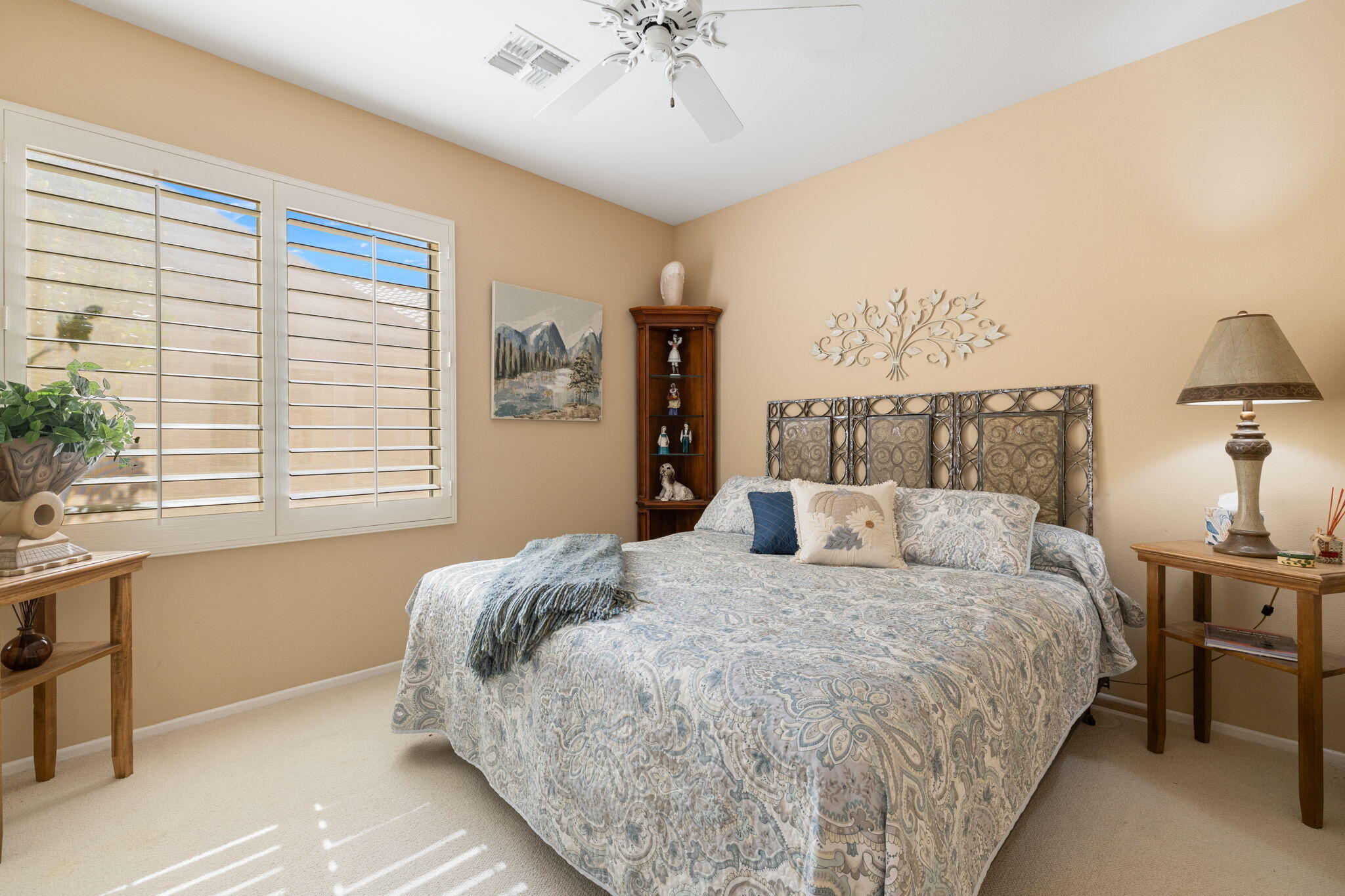 39611 Manorgate Road Palm Desert, CA 92211 - Photo 26 of 45 a bedroom with a large bed and a chandelier