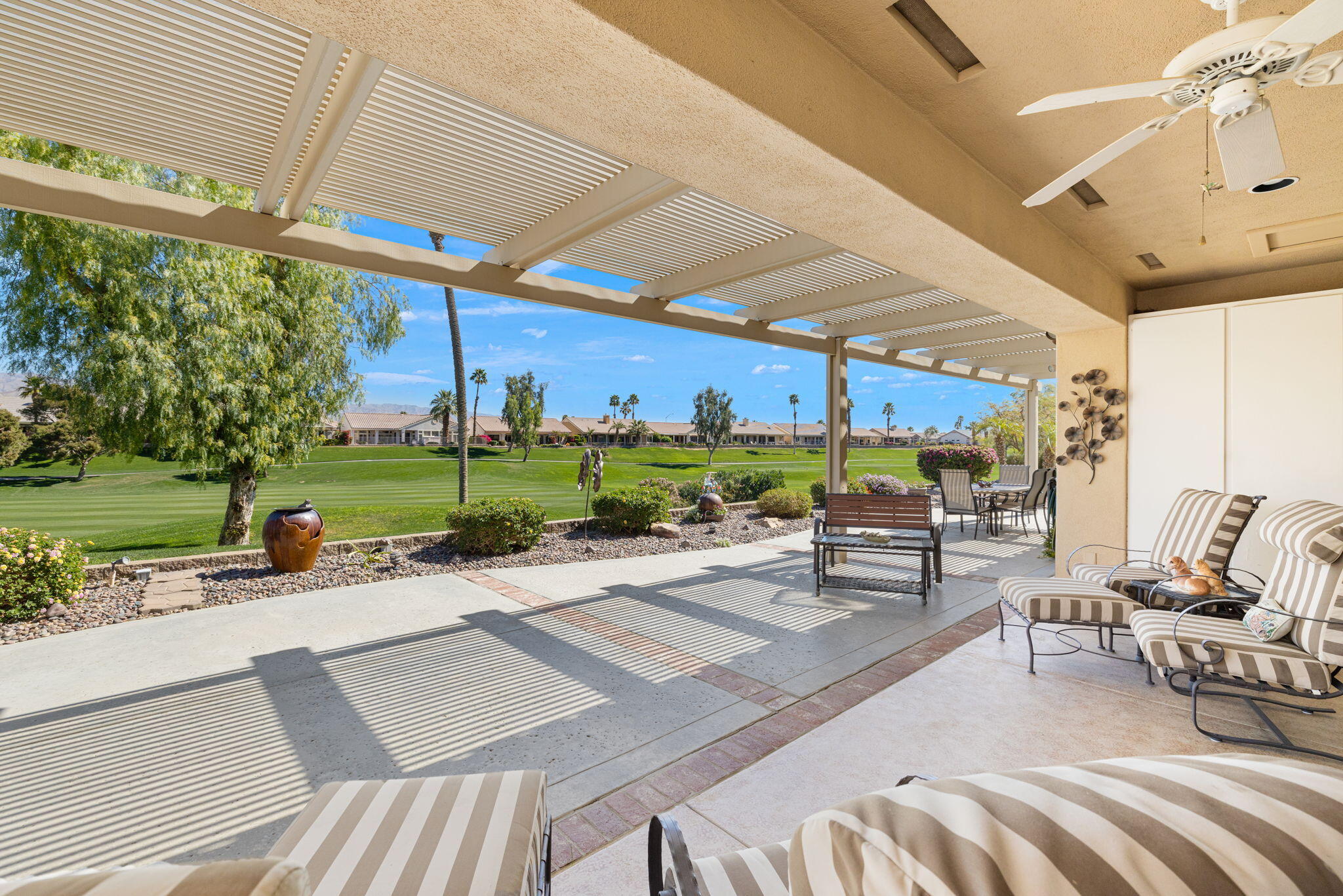 39611 Manorgate Road Palm Desert, CA 92211 - Photo 34 of 45 a view of a patio with a table and chairs