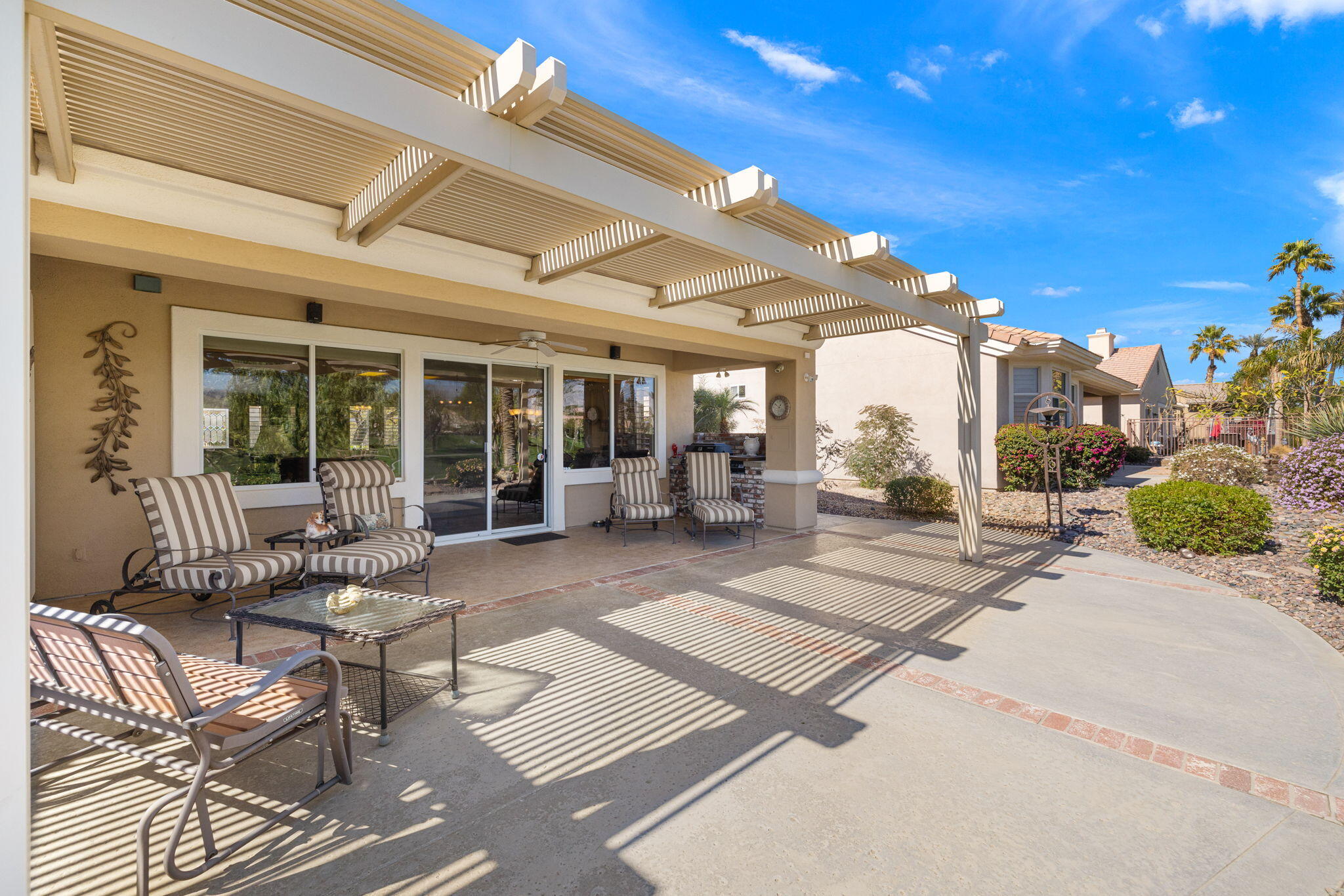 39611 Manorgate Road Palm Desert, CA 92211 - Photo 36 of 45 a view of a patio with table and chairs and potted plants
