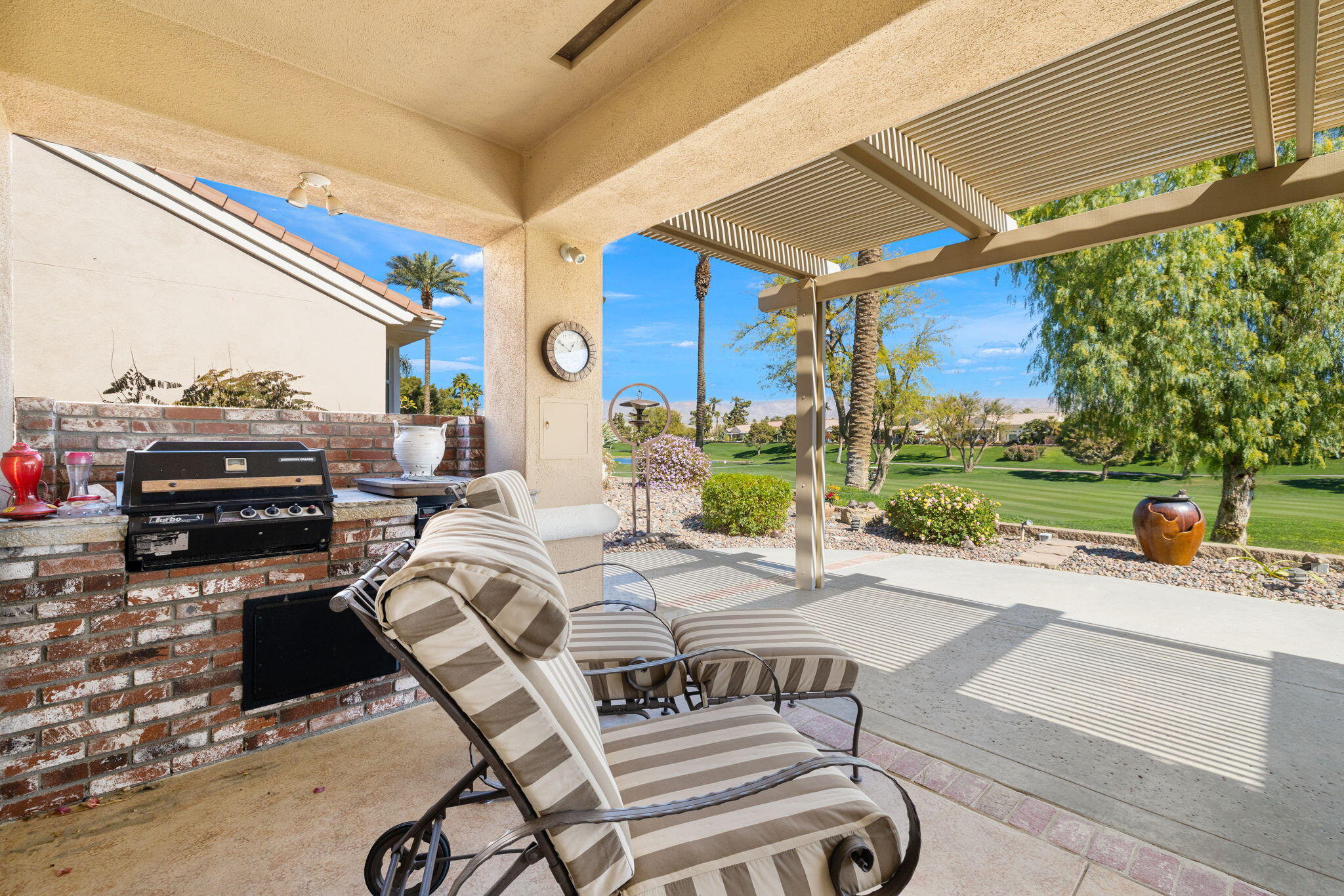 39611 Manorgate Road Palm Desert, CA 92211 - Photo 37 of 45 a view of a patio with a table and chairs