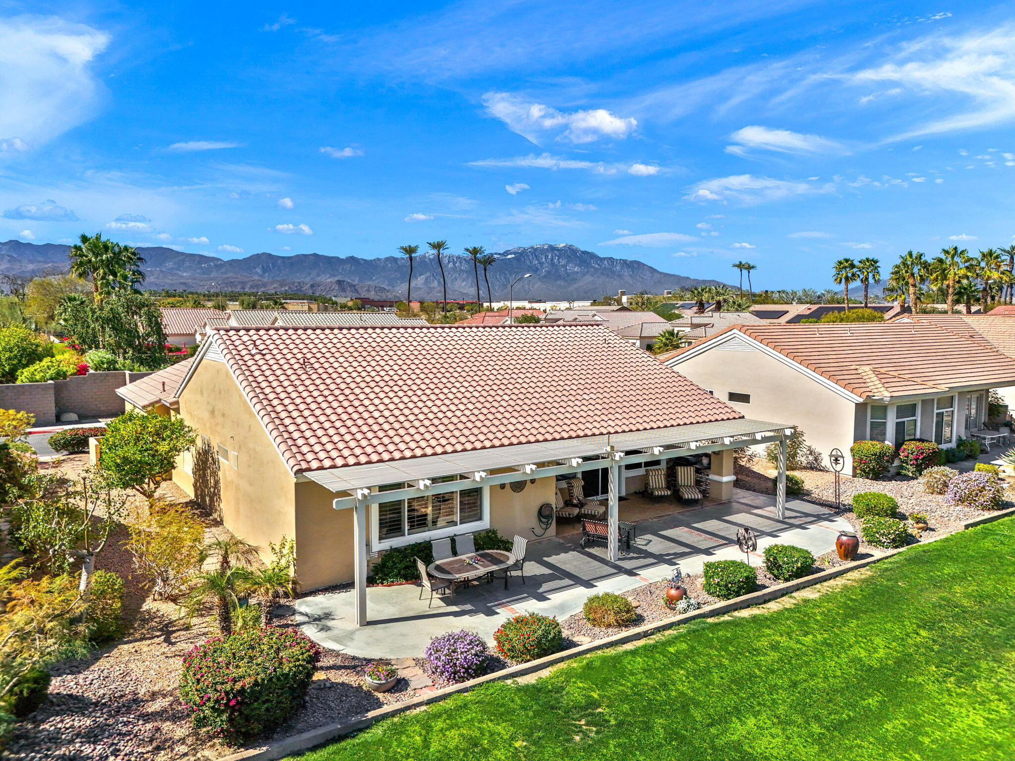 39611 Manorgate Road Palm Desert, CA 92211 - Photo 38 of 45 a view of a patio with table and chairs and potted plants