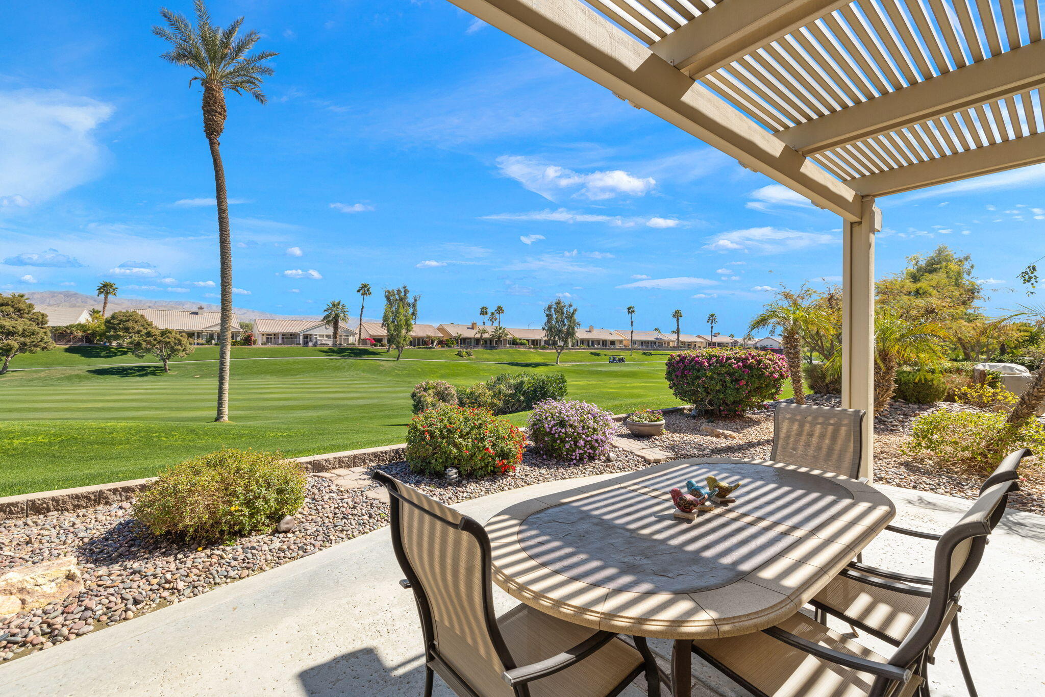 39611 Manorgate Road Palm Desert, CA 92211 - Photo 41 of 45 a view of a patio with a table chairs and a table
