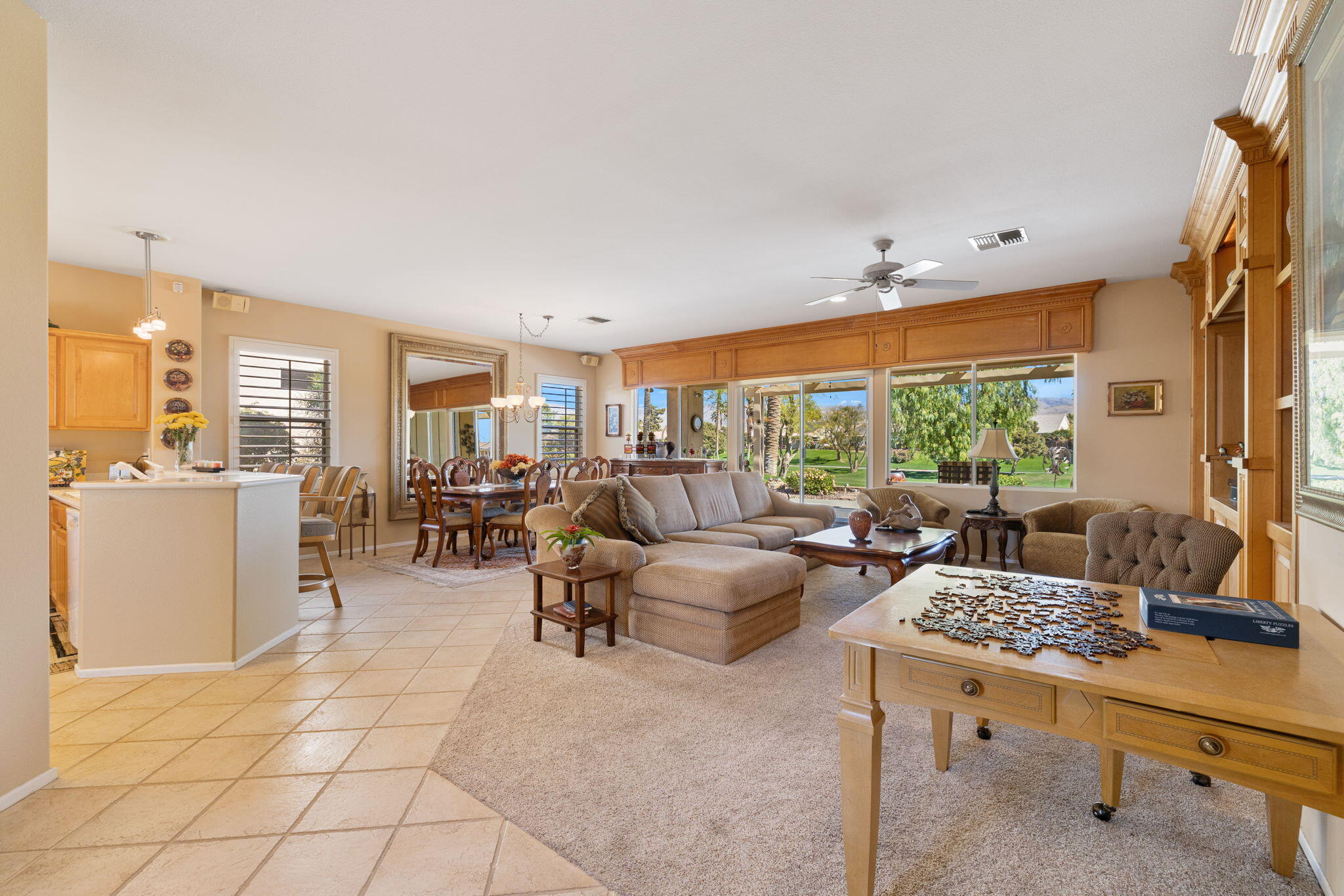 39611 Manorgate Road Palm Desert, CA 92211 - Photo 6 of 45 a living room with furniture and a large window