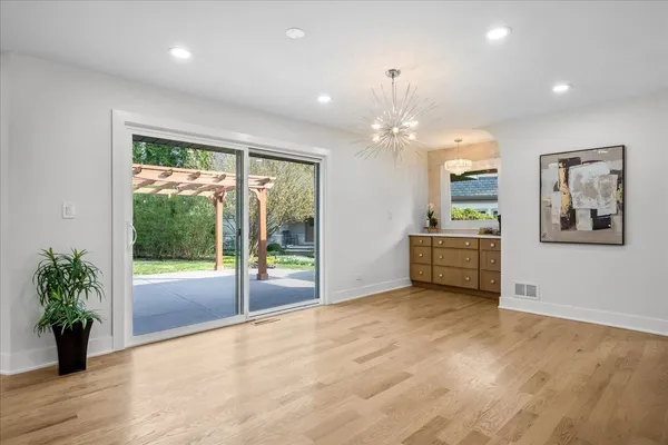 a view of a big room with wooden floor and windows