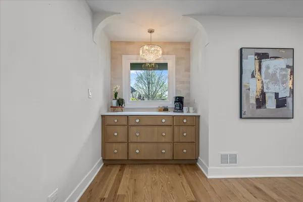 a room with painting on the wall and a window