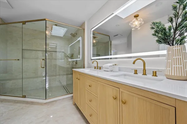 a bathroom with a shower sink and mirror