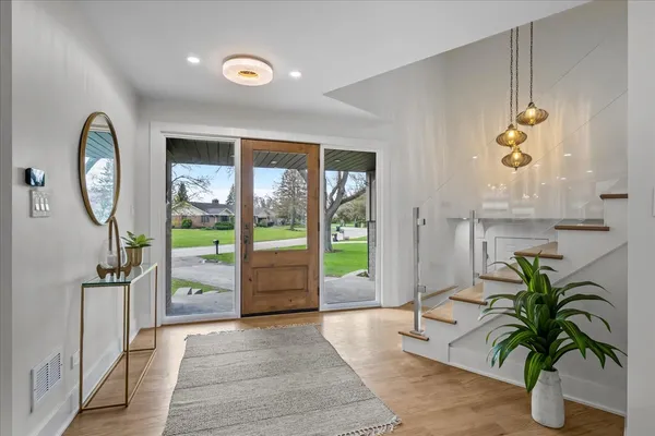 a very nice looking living room with a large window and wooden floor