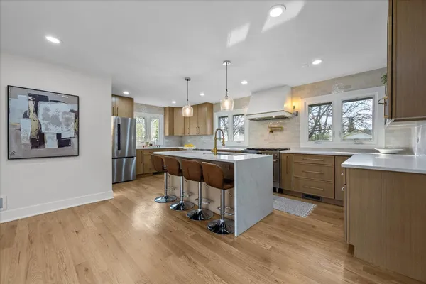a kitchen with a sink cabinets and wooden floor