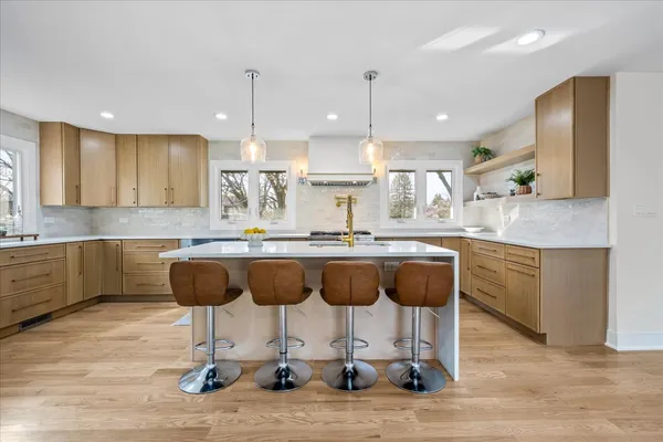 a kitchen with kitchen island granite countertop wooden cabinets and a granite counter tops