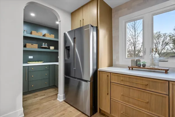 a kitchen with a refrigerator and a sink